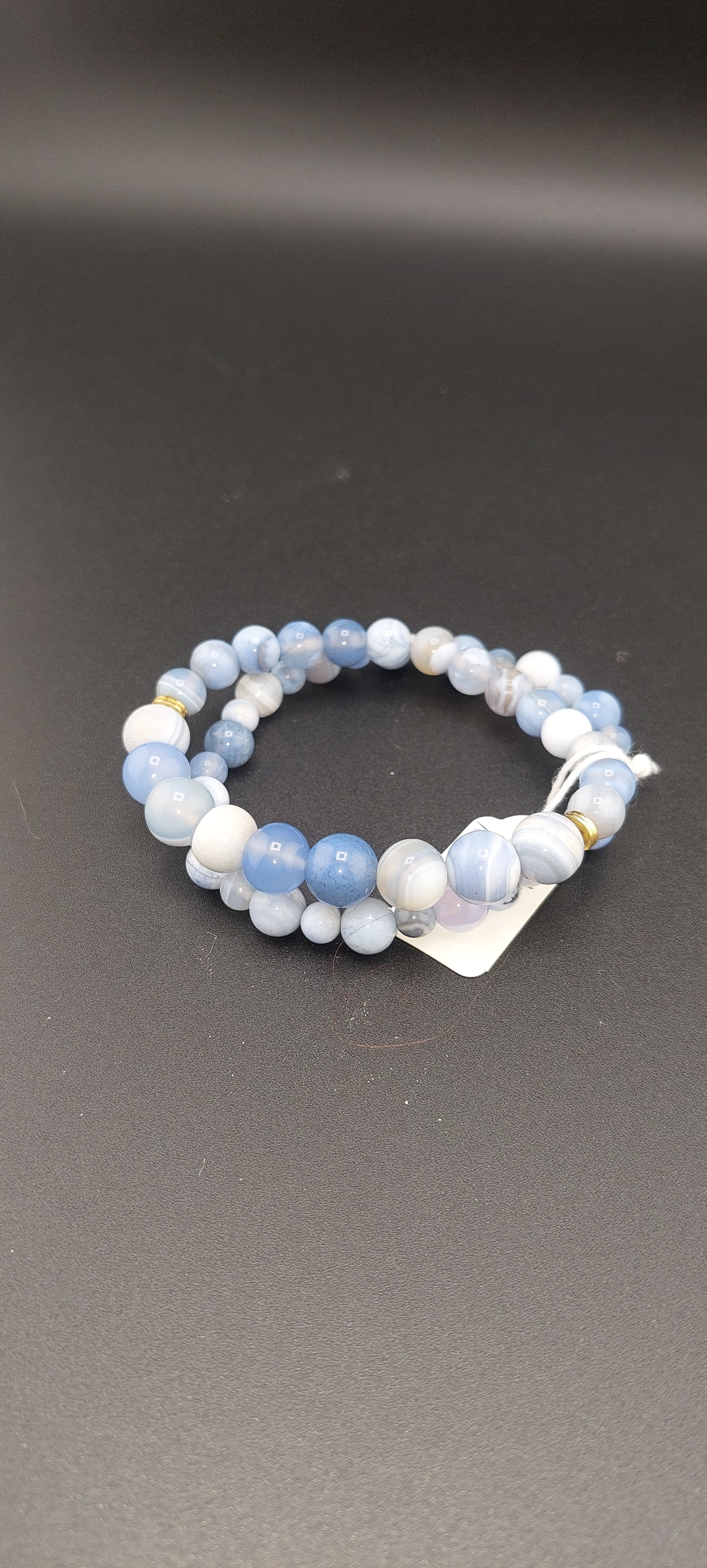A two-tone blue and white beaded bracelet made of Blue Lace Agate.