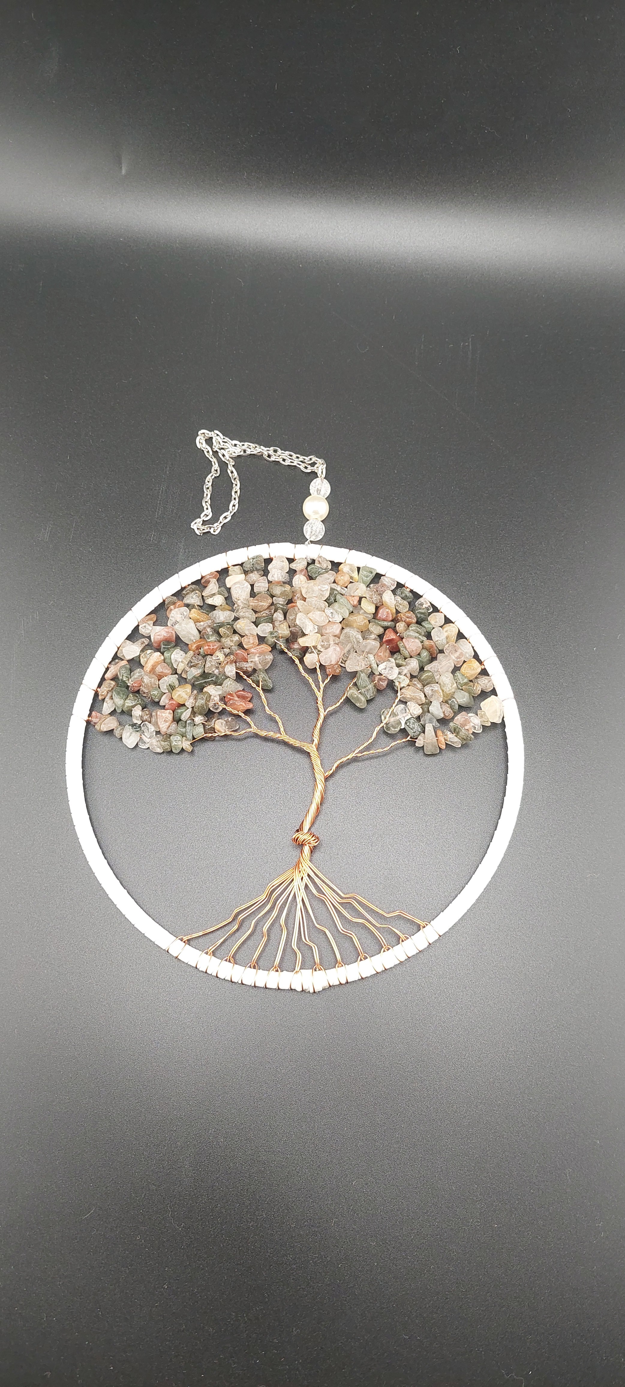 A dream catcher featuring a Tree of Life design, with non-tarnish wire and garden quartz.