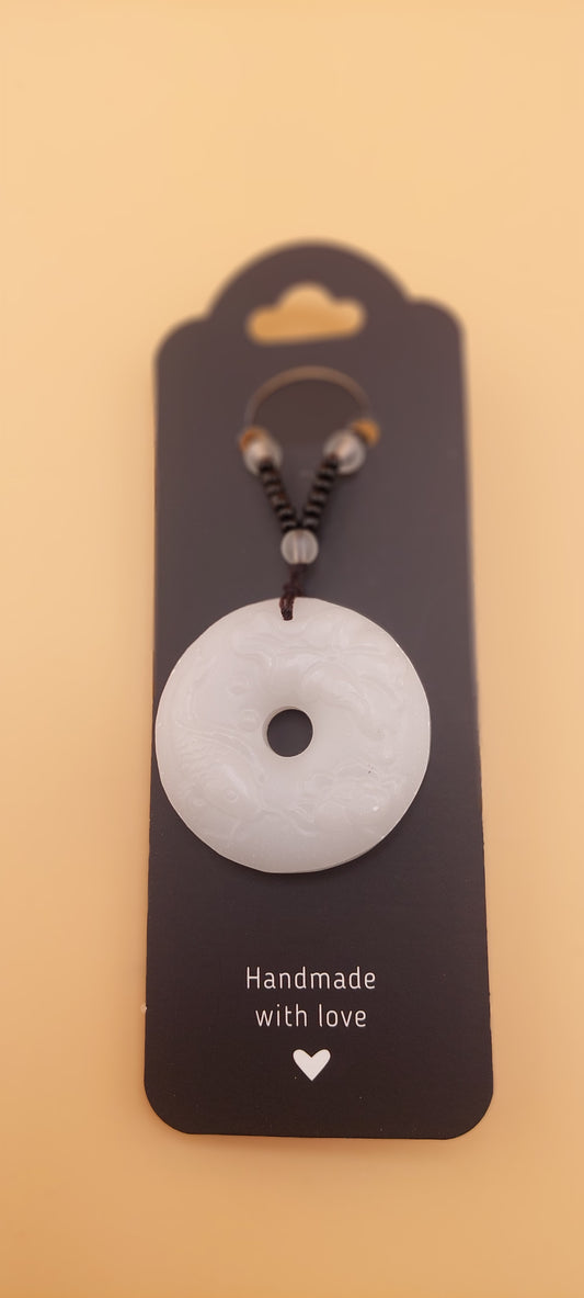 A white jade Koy fish bracelet on a black display card with the text 'Handmade with love'.