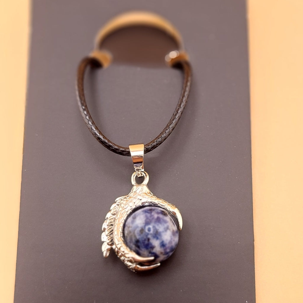 A men's necklace featuring an eagle claw pendant with sodalite stone set in silver, displayed against a black background with a leather-like choker.