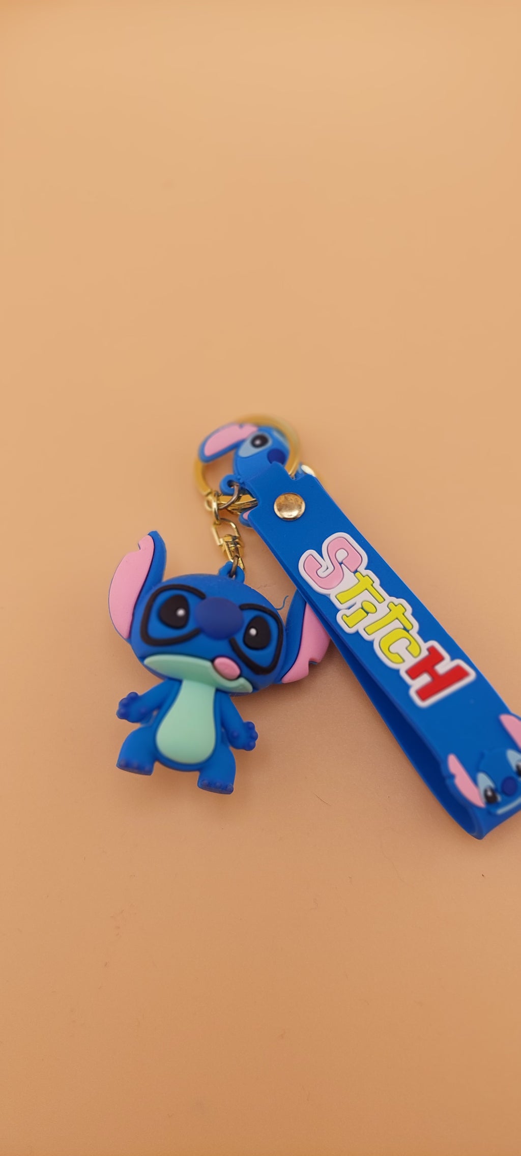 A blue Stitch keychain from the Lilo and Stitch series, displayed against a neutral background.