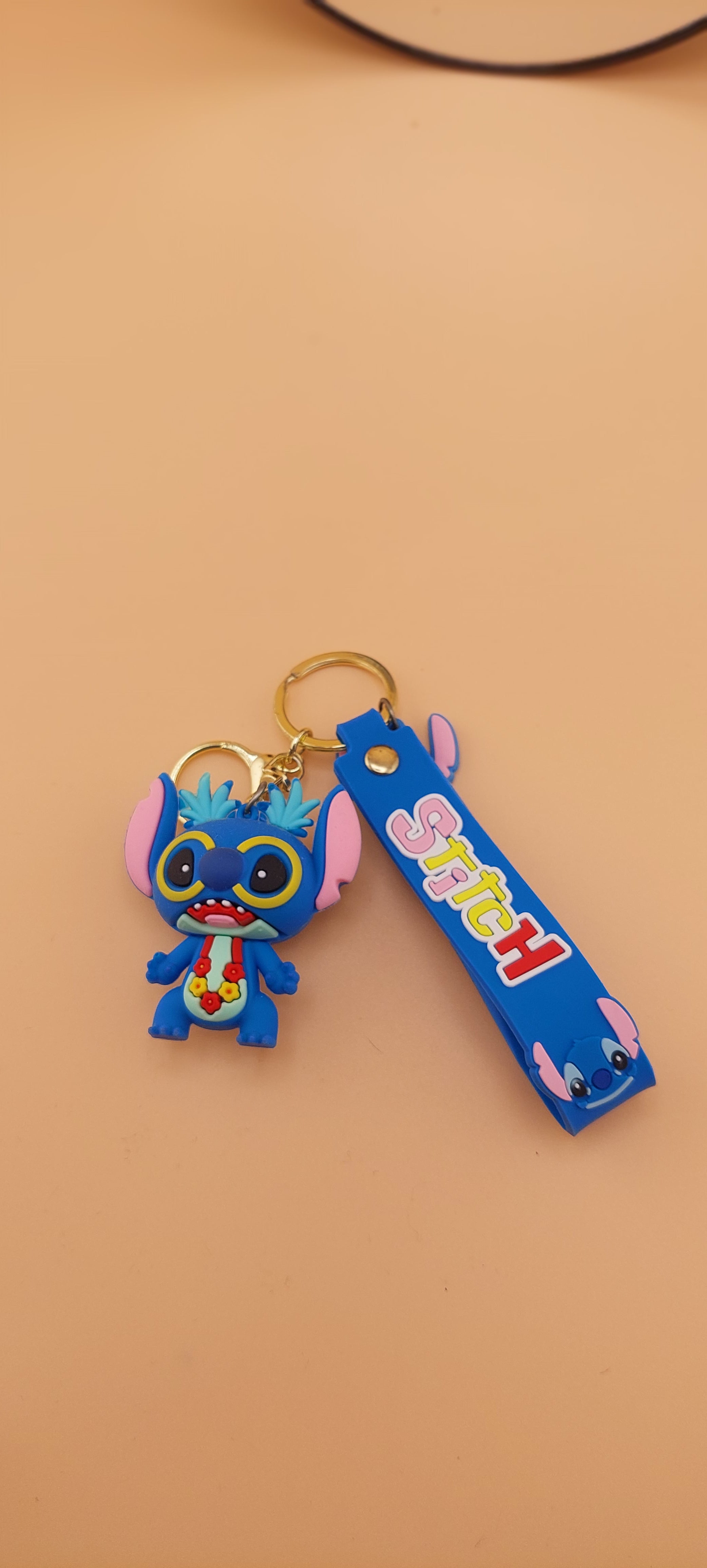 A blue Stitch keychain from the Lilo and Stitch series, displayed against a neutral background.