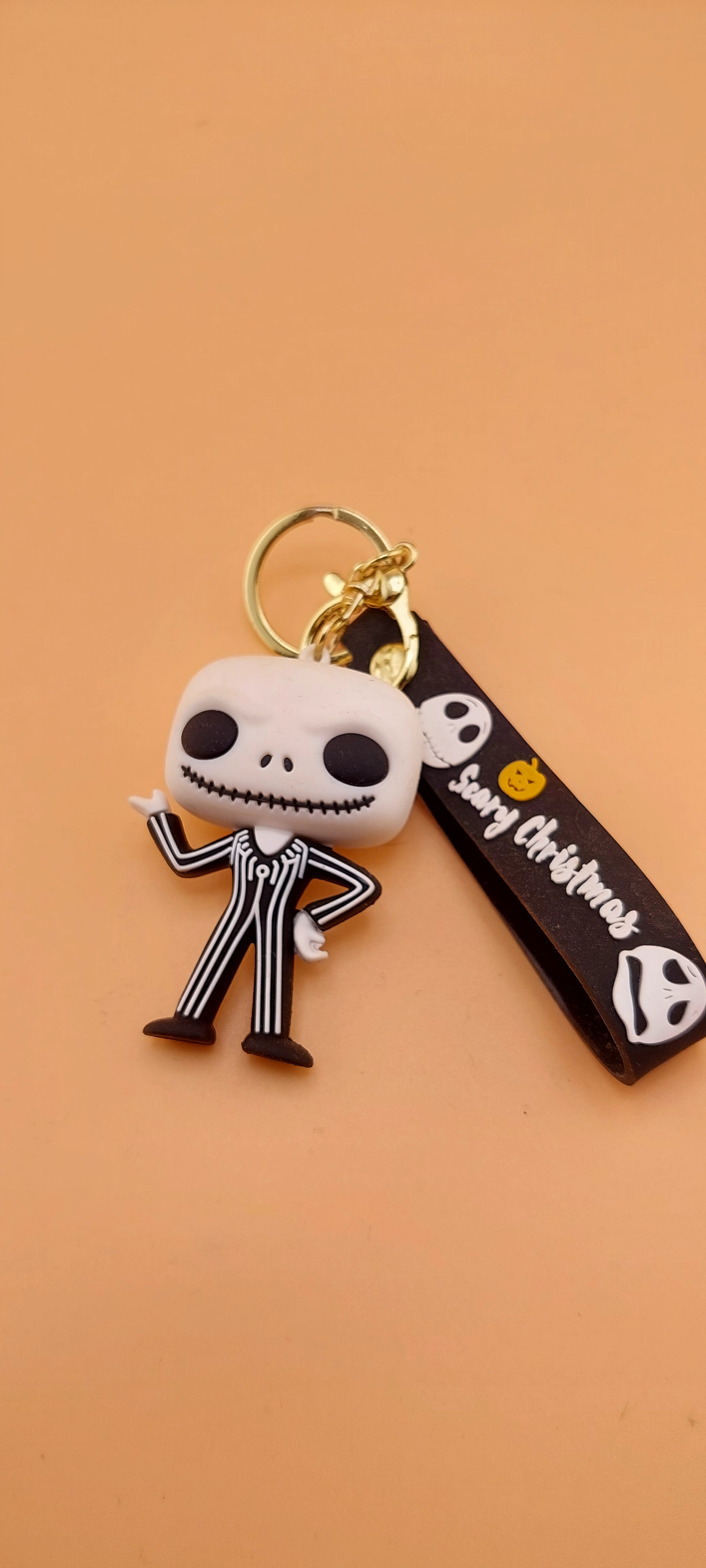 A keychain featuring an animated character from 'The Nightmare Before Christmas' attached to a brown strap with the text 'DEATH NOTE'.