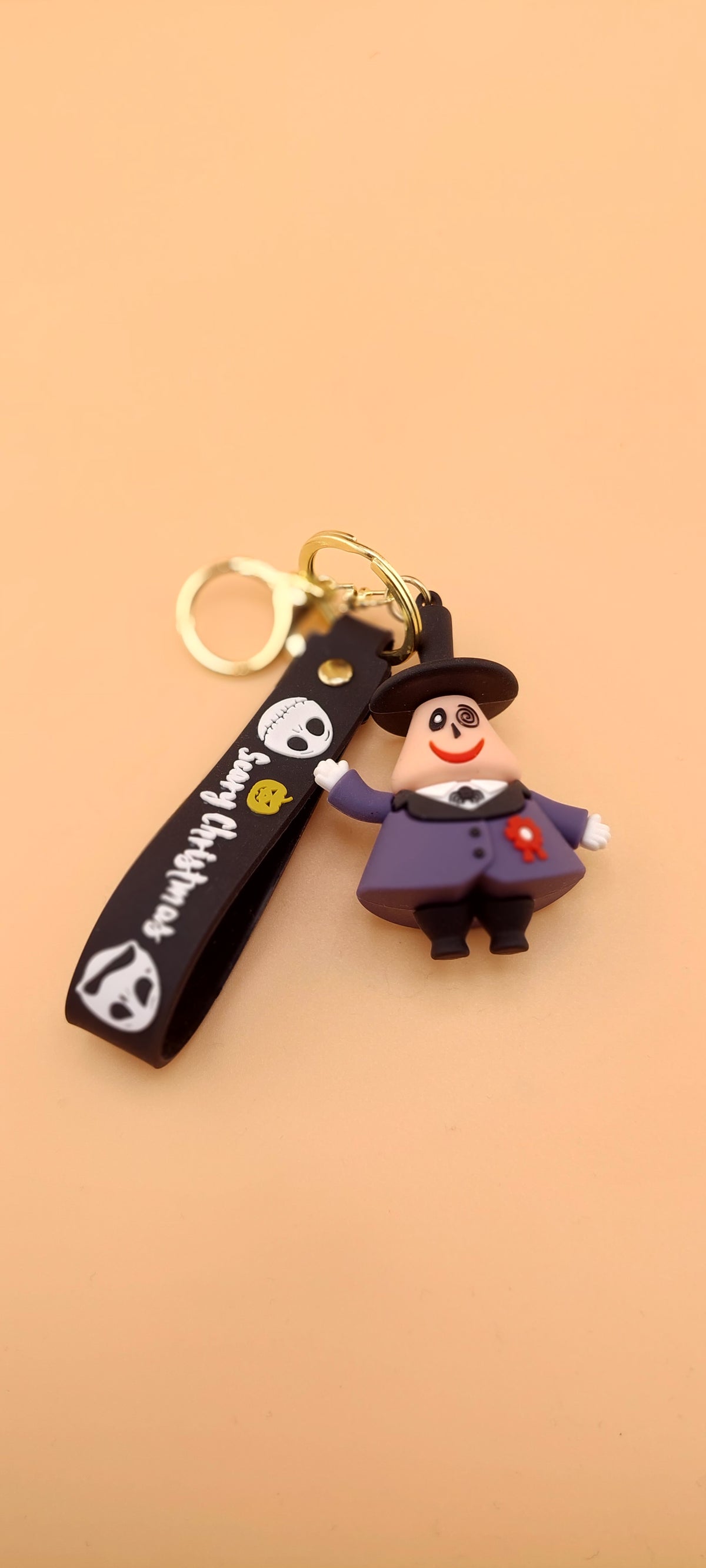 A keychain featuring an animated character from 'The Nightmare Before Christmas' attached to a brown strap with the text 'DEATH NOTE'.