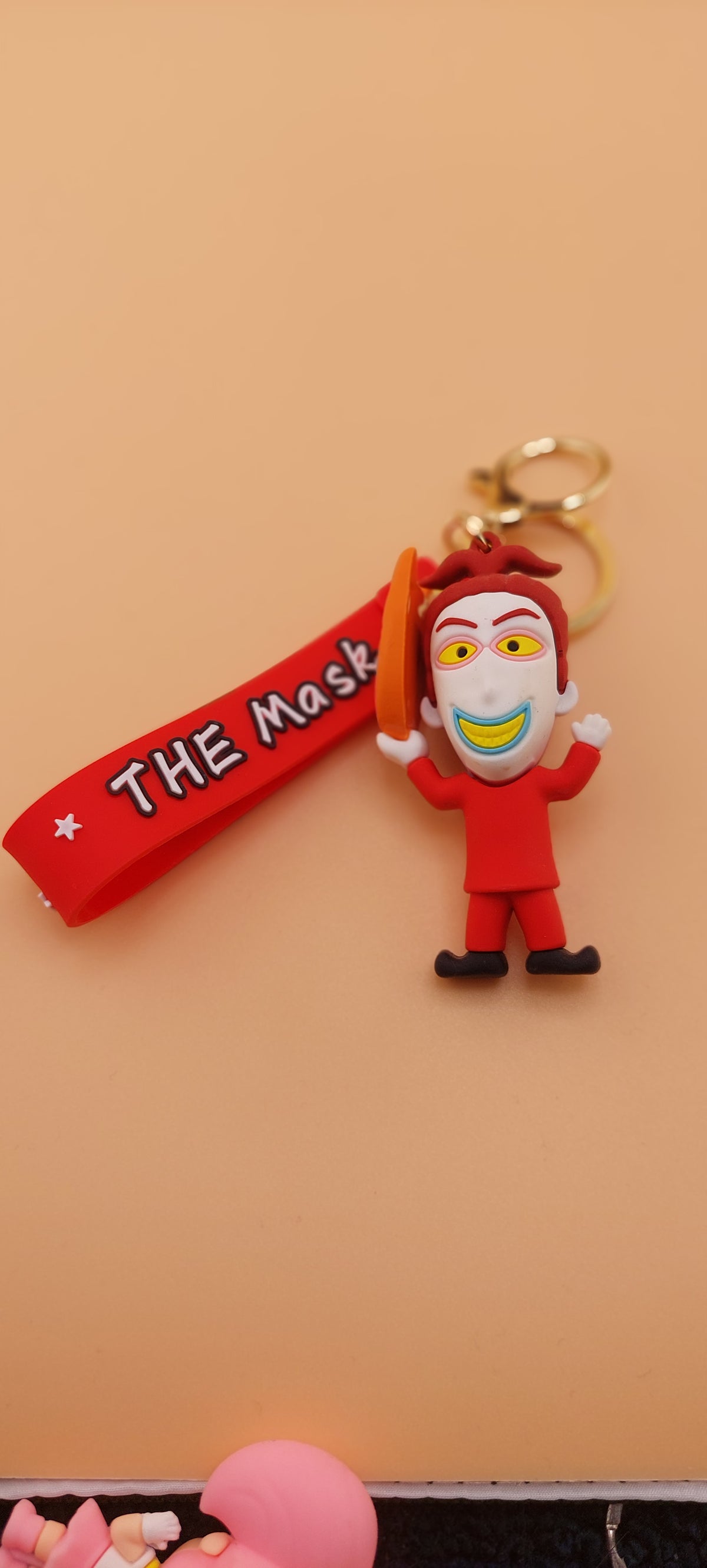 A keychain featuring an animated character from 'The Nightmare Before Christmas' attached to a brown strap with the text 'DEATH NOTE'.