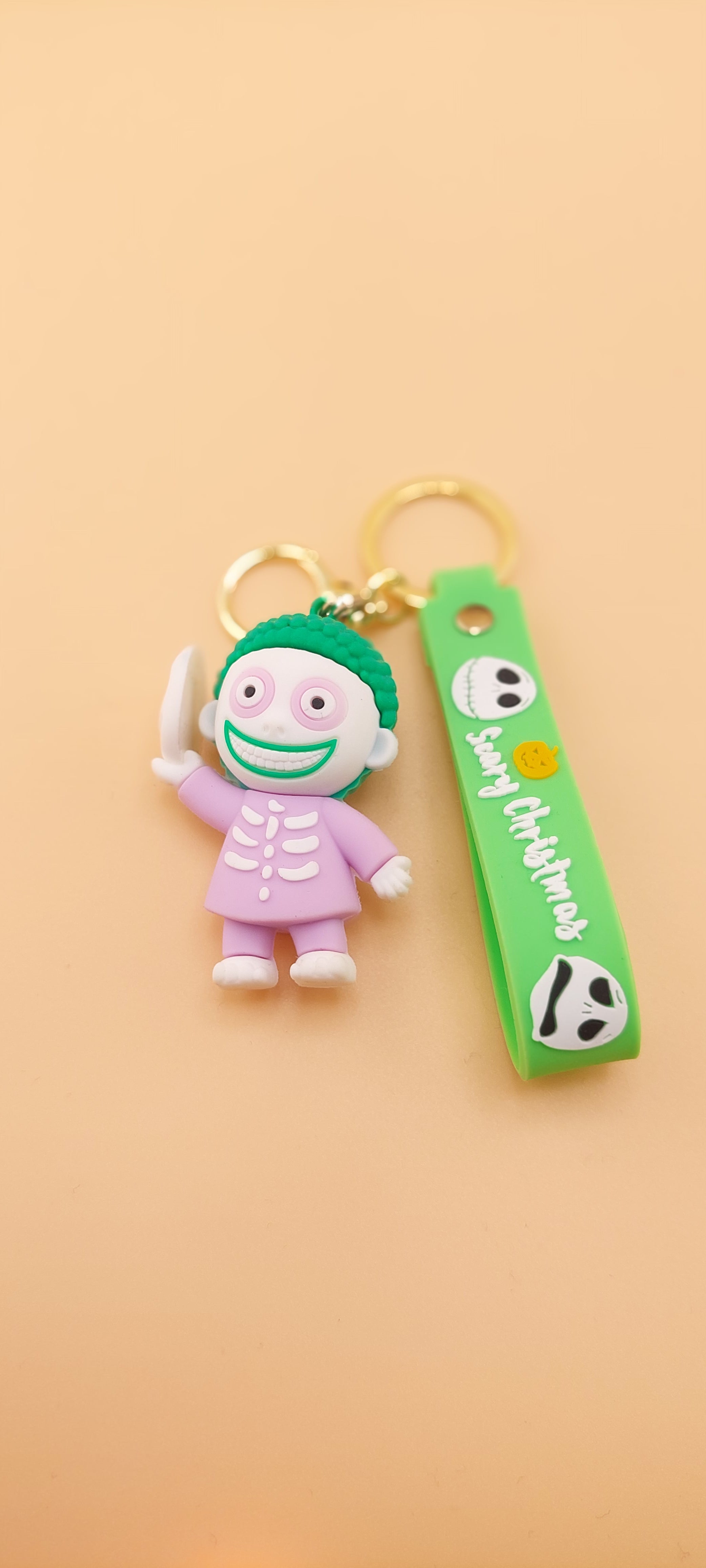 A keychain featuring an animated character from 'The Nightmare Before Christmas' attached to a brown strap with the text 'DEATH NOTE'.