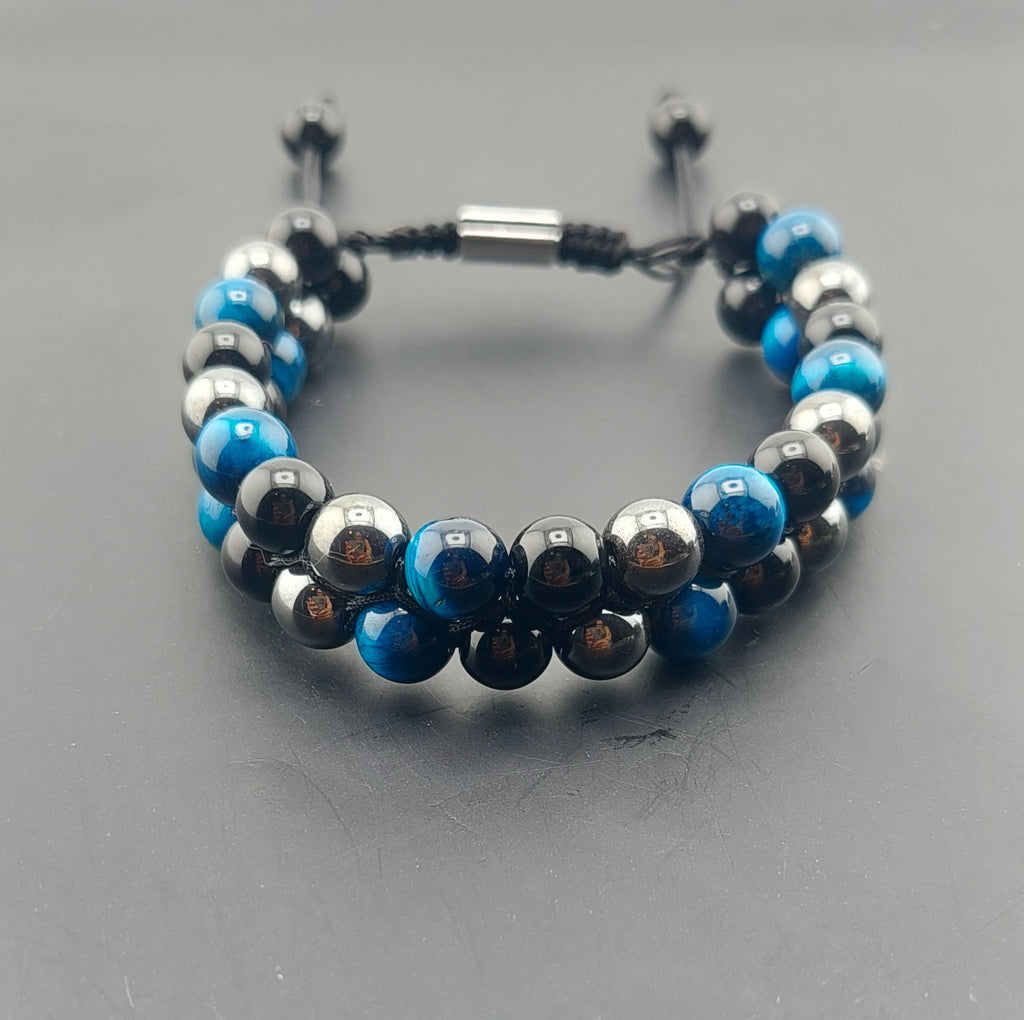 A men's macrame bracelet with blue and black beads, featuring an adjustable closure.