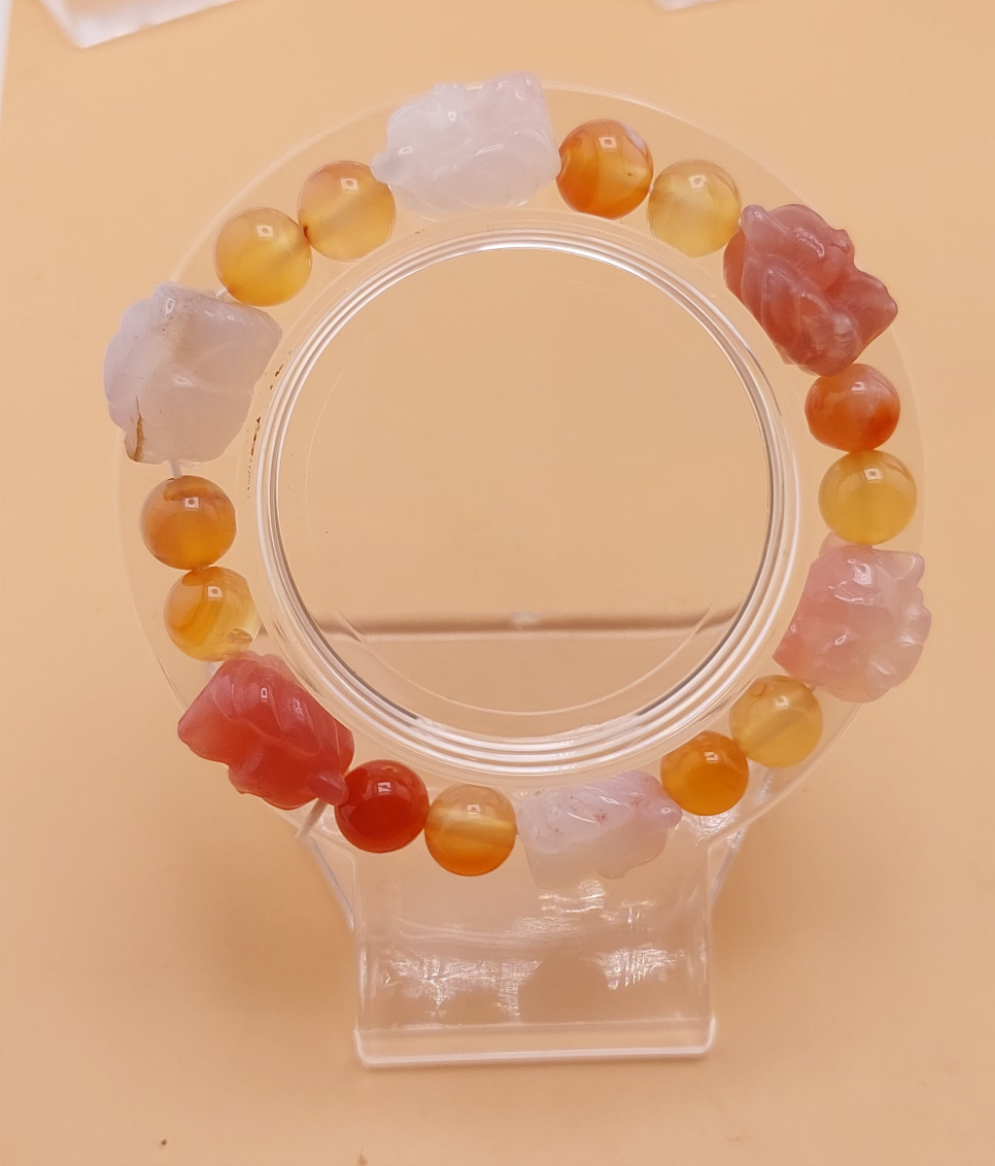A bracelet made with multicolored beads, featuring a mix of translucent and opaque Agate stones, displayed against a neutral background.
