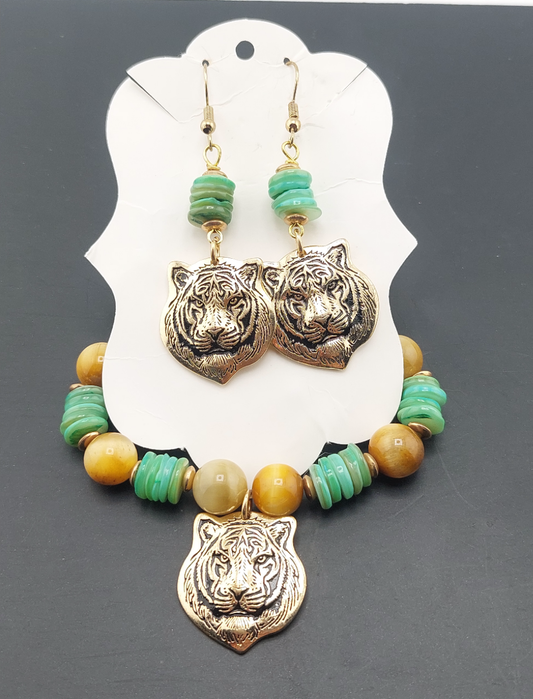 A set of jewelry featuring tiger charm pendants and tiger eye stones on a necklace and matching earrings, displayed on a white card.