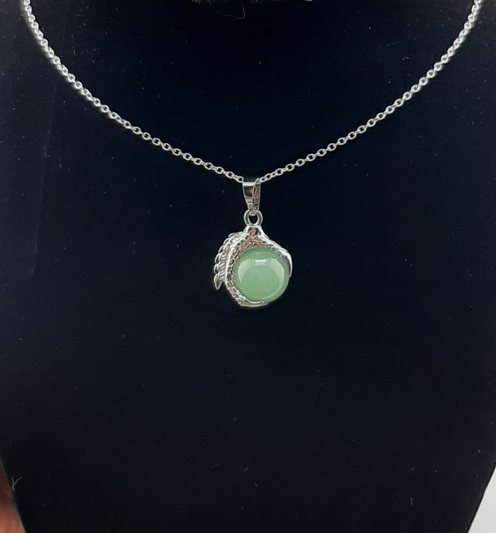 A men's necklace featuring an eagle claw pendant with sodalite stone set in silver, displayed against a black background with a leather-like choker.