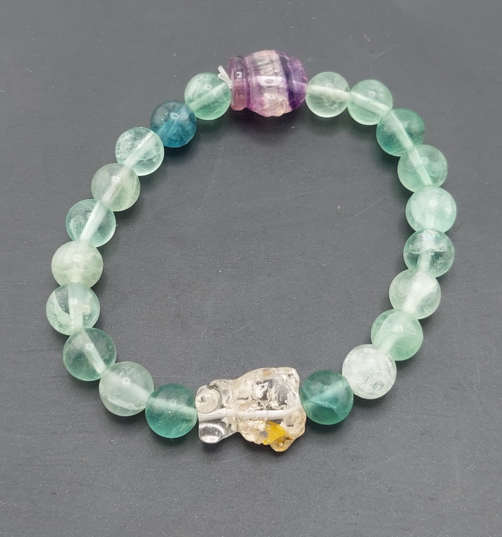 A Hello Kitty themed fluorite bracelet with multicolored beads and a character charm.