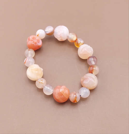 A multicolored beaded bracelet with a smooth, round shape displayed against a neutral background.