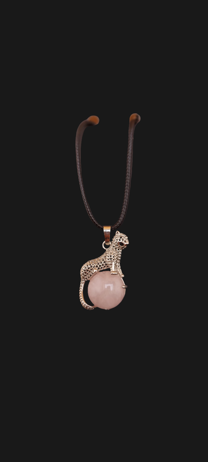 A leopard-shaped necklace with a pink pendant, displayed on a black card that reads 'Handmade with love from jade couture texas'.