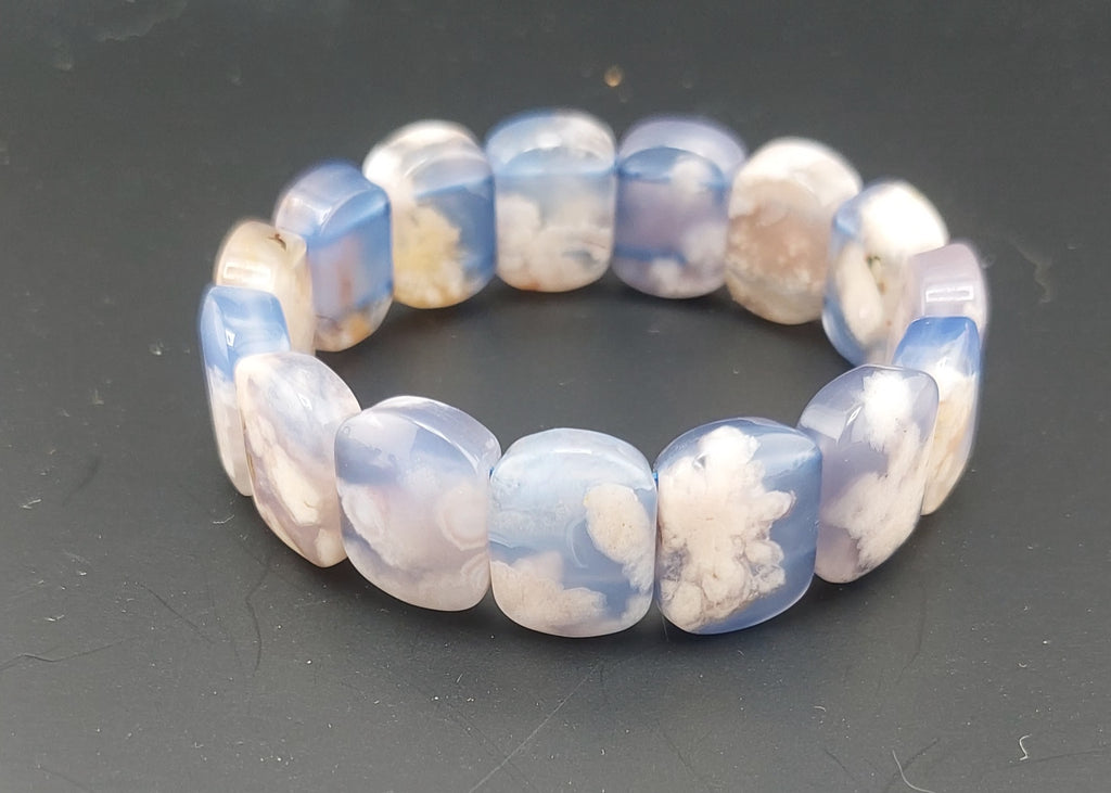 Beaded bracelet with blue and white pattern on a dark surface