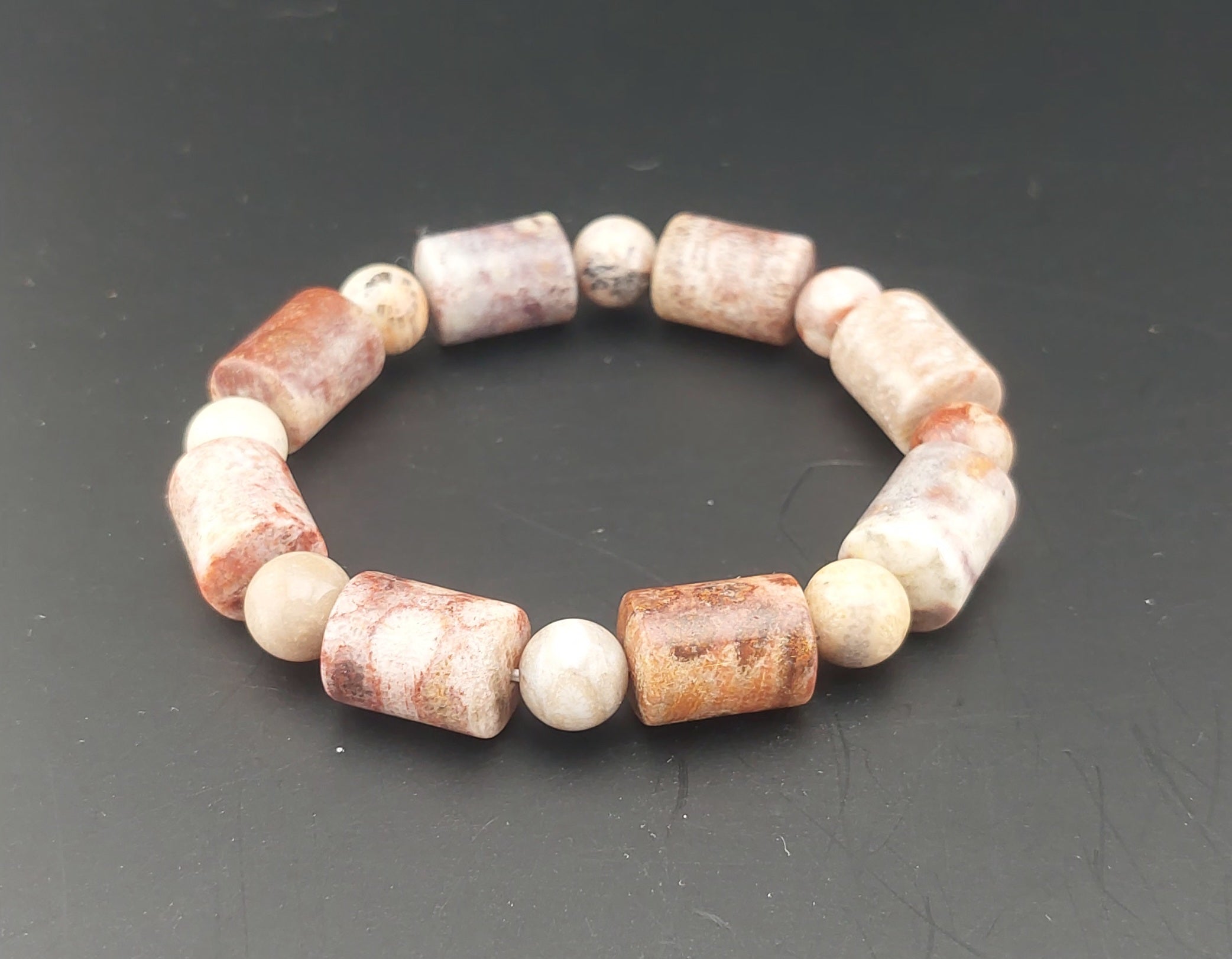 Beaded bracelet with natural stone beads on a dark surface