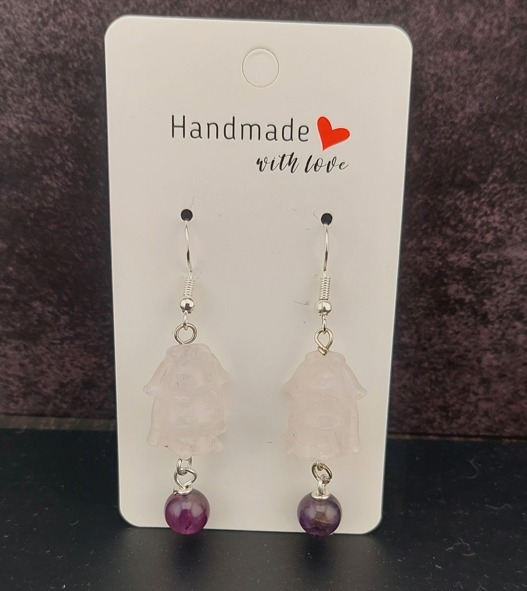 Handmade earrings with pink stones and purple beads on a card labeled 'Handmade with Love'.