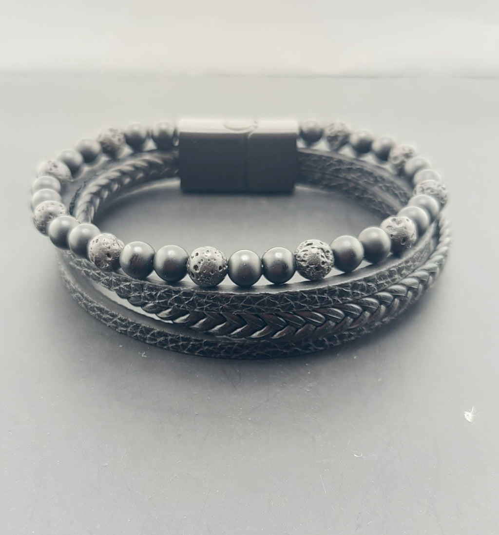 Bracelet with braided design and beaded section on a light gray background