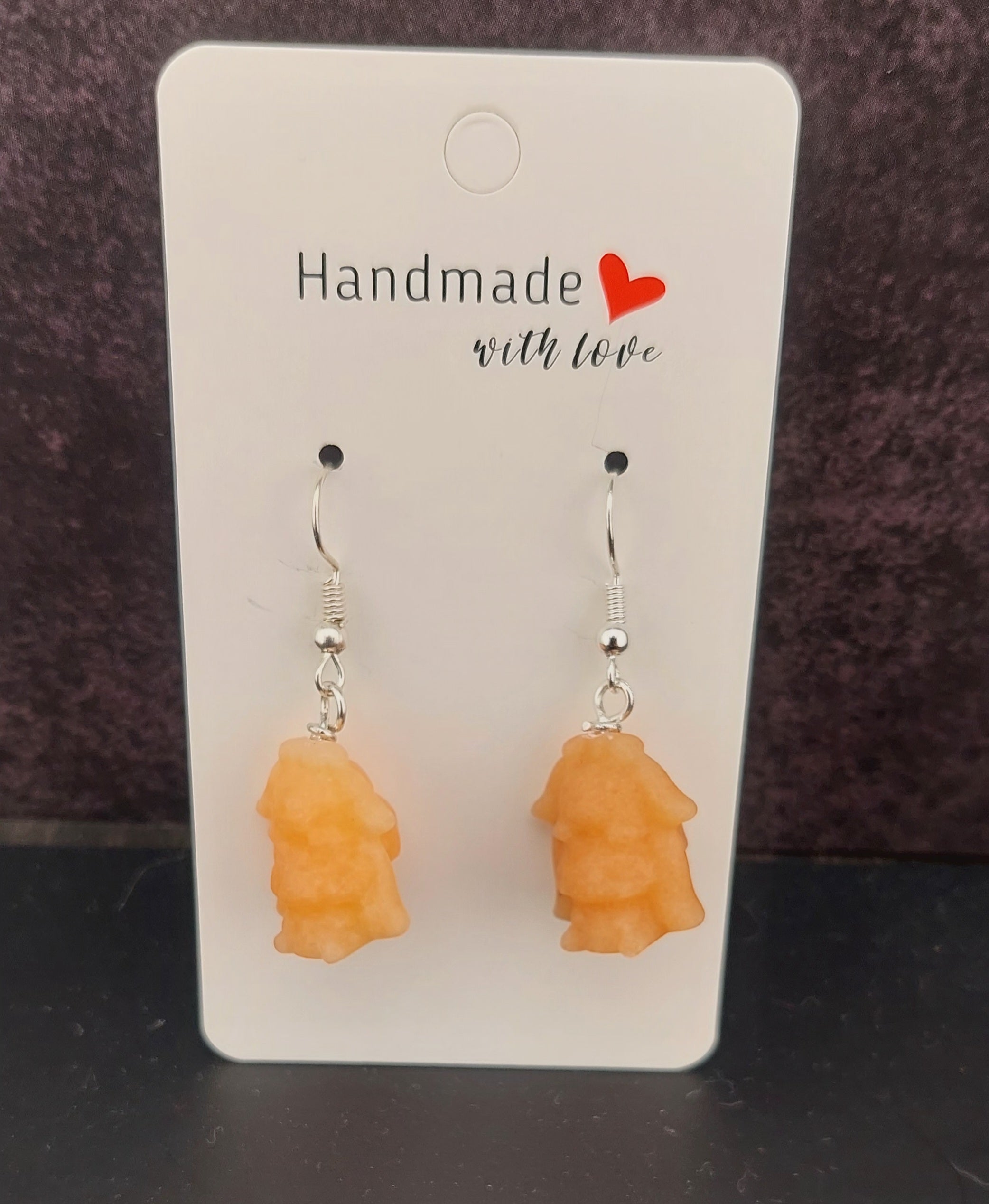 Handmade orange cinnamon roll earrings on a card with 'Handmade with Love' text.
