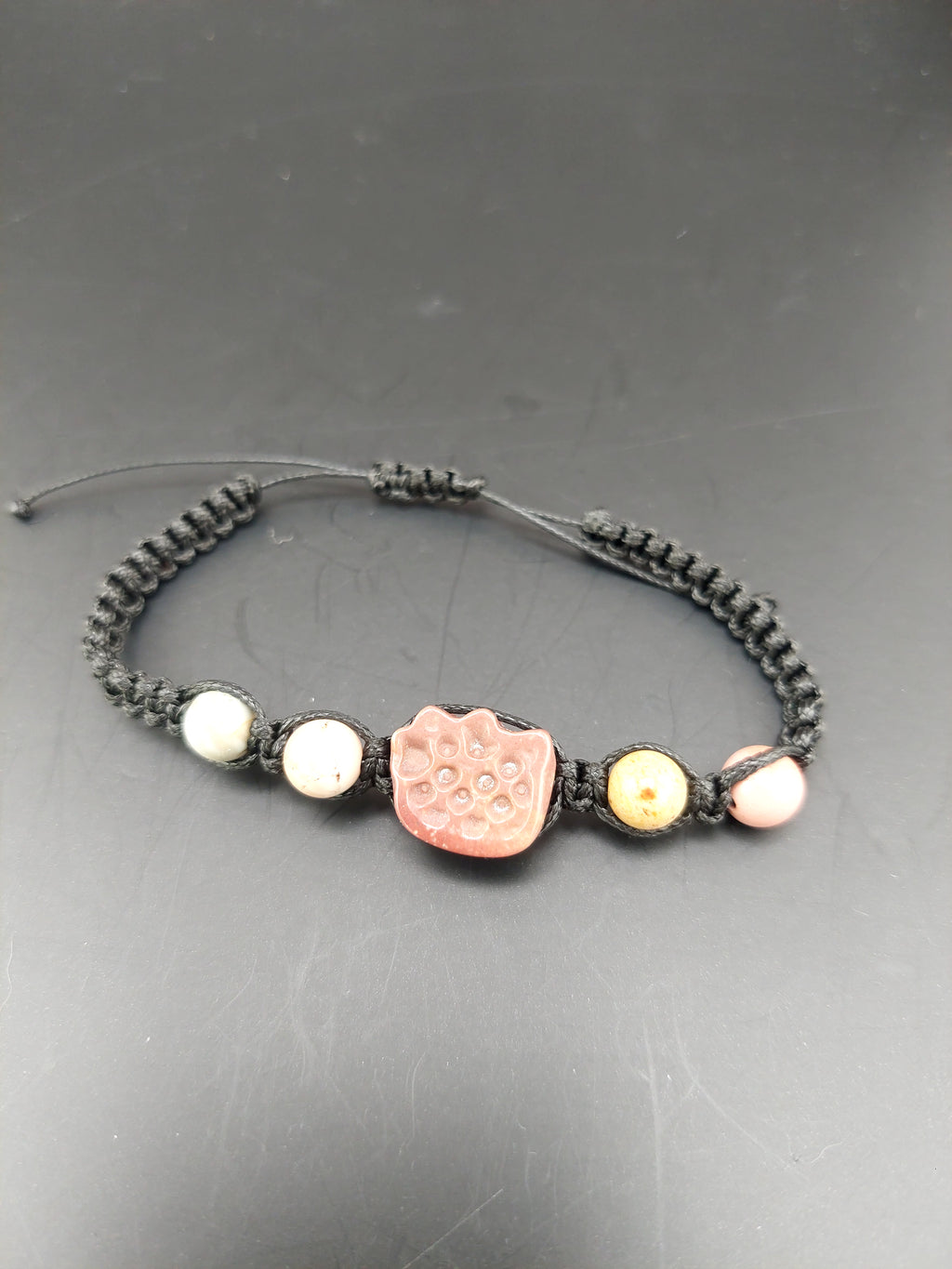 Bracelet with decorative beads on a gray surface