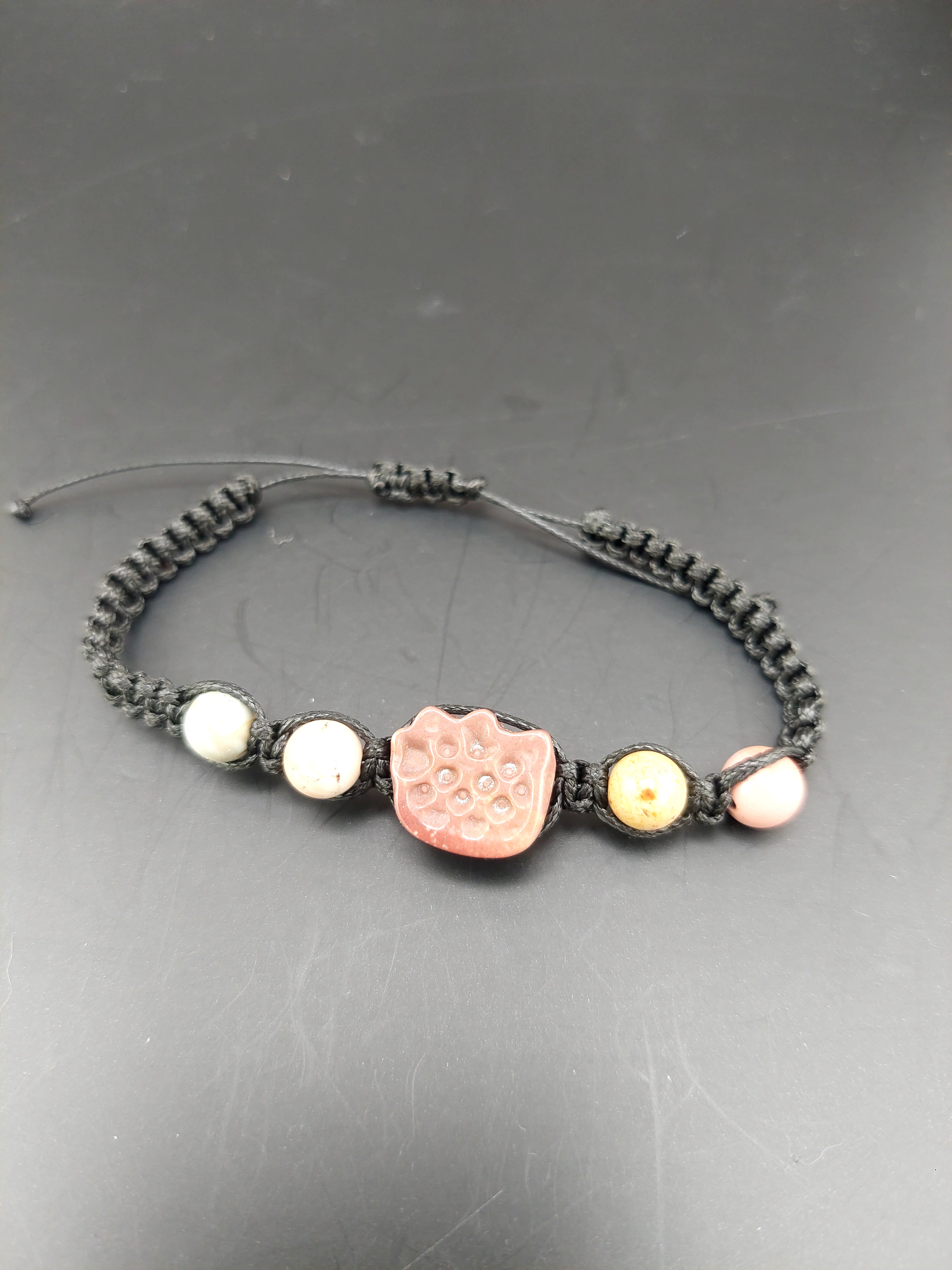 Bracelet with decorative beads on a gray surface