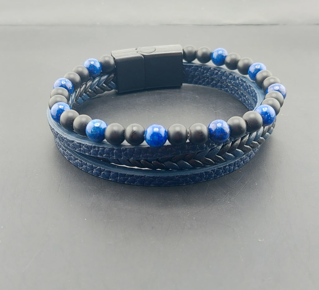 Blue and gray beaded bracelet on a gray background